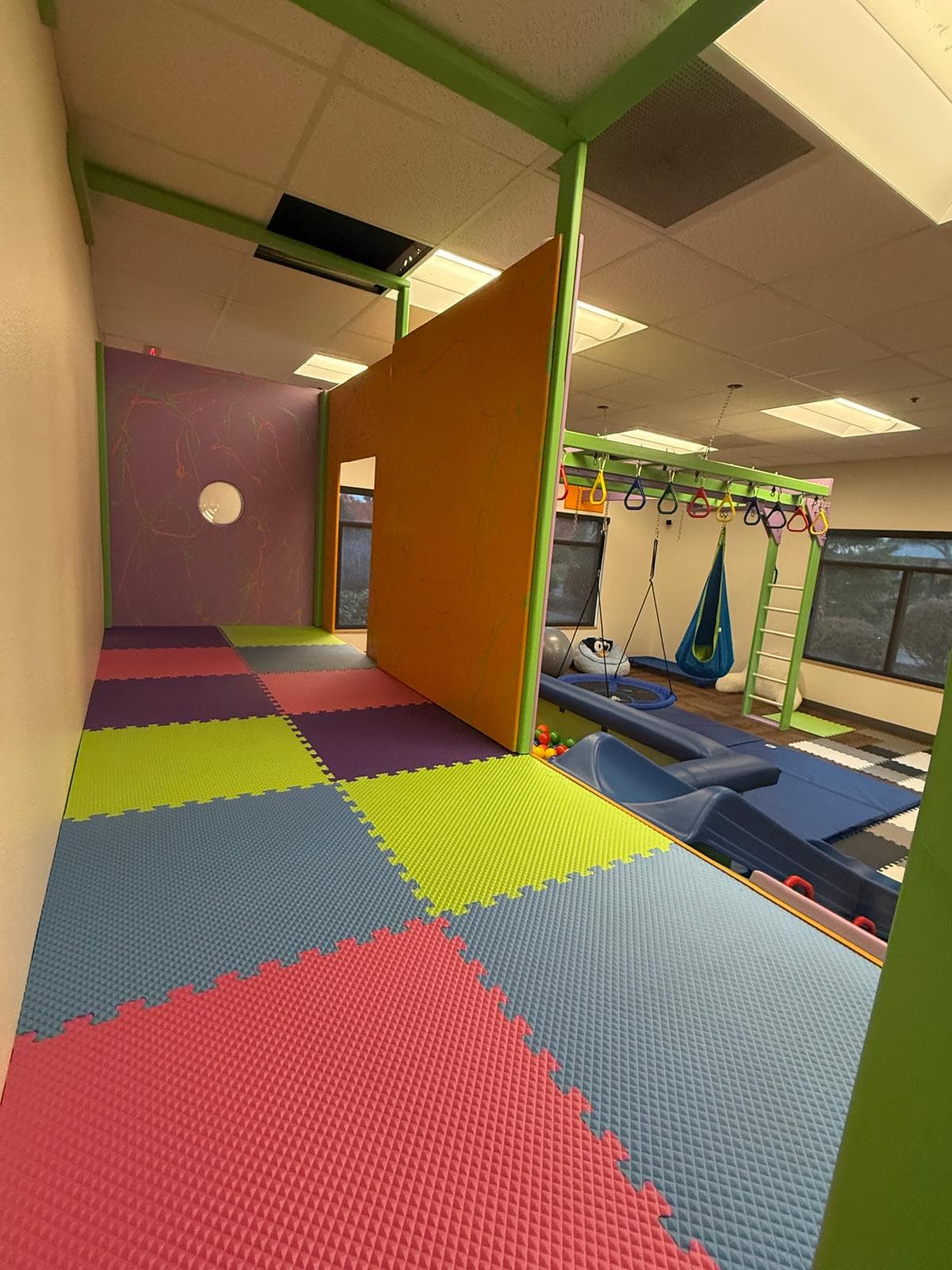 Bright therapy room with sensory stations