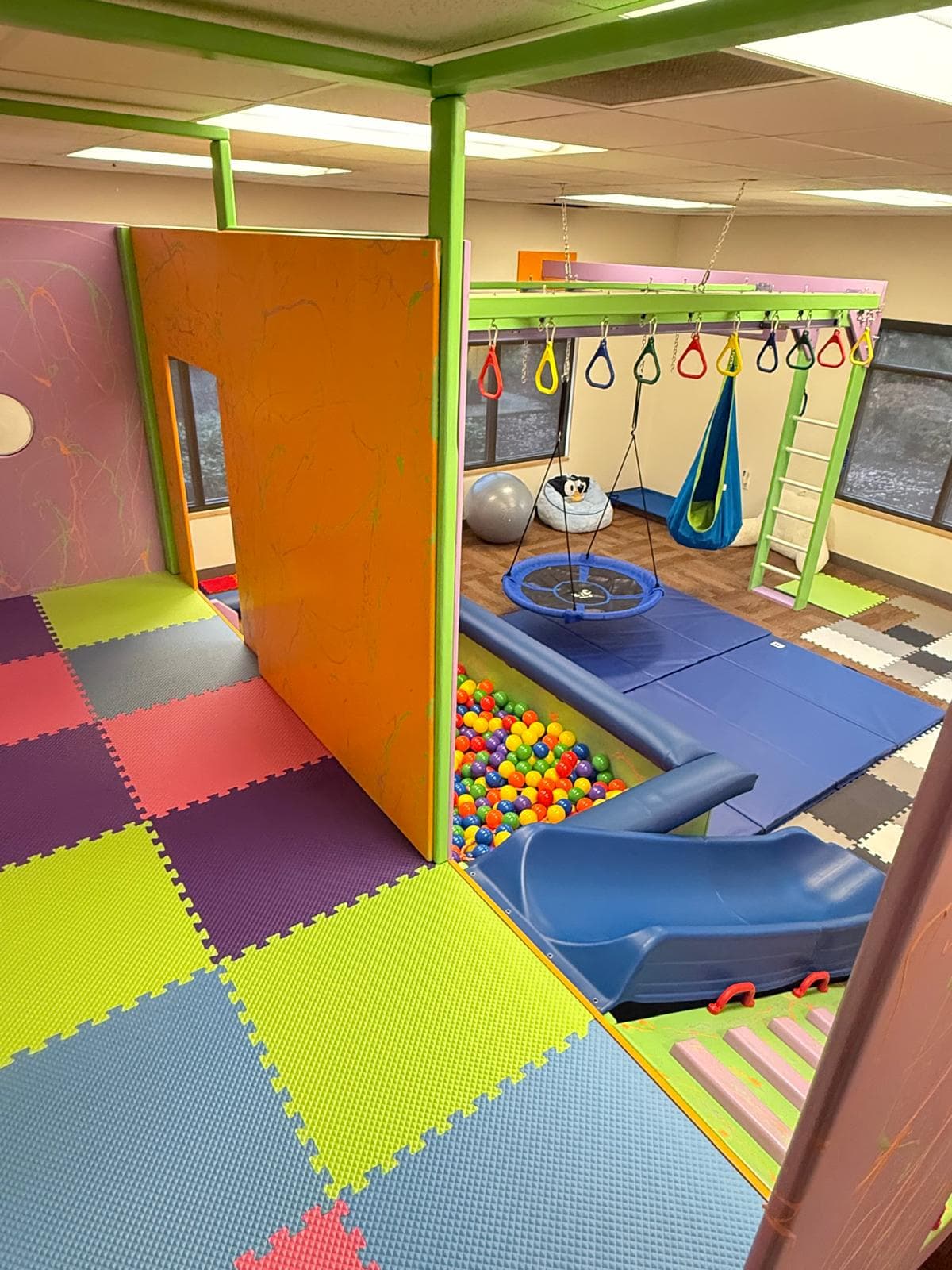 Bright therapy room with sensory stations