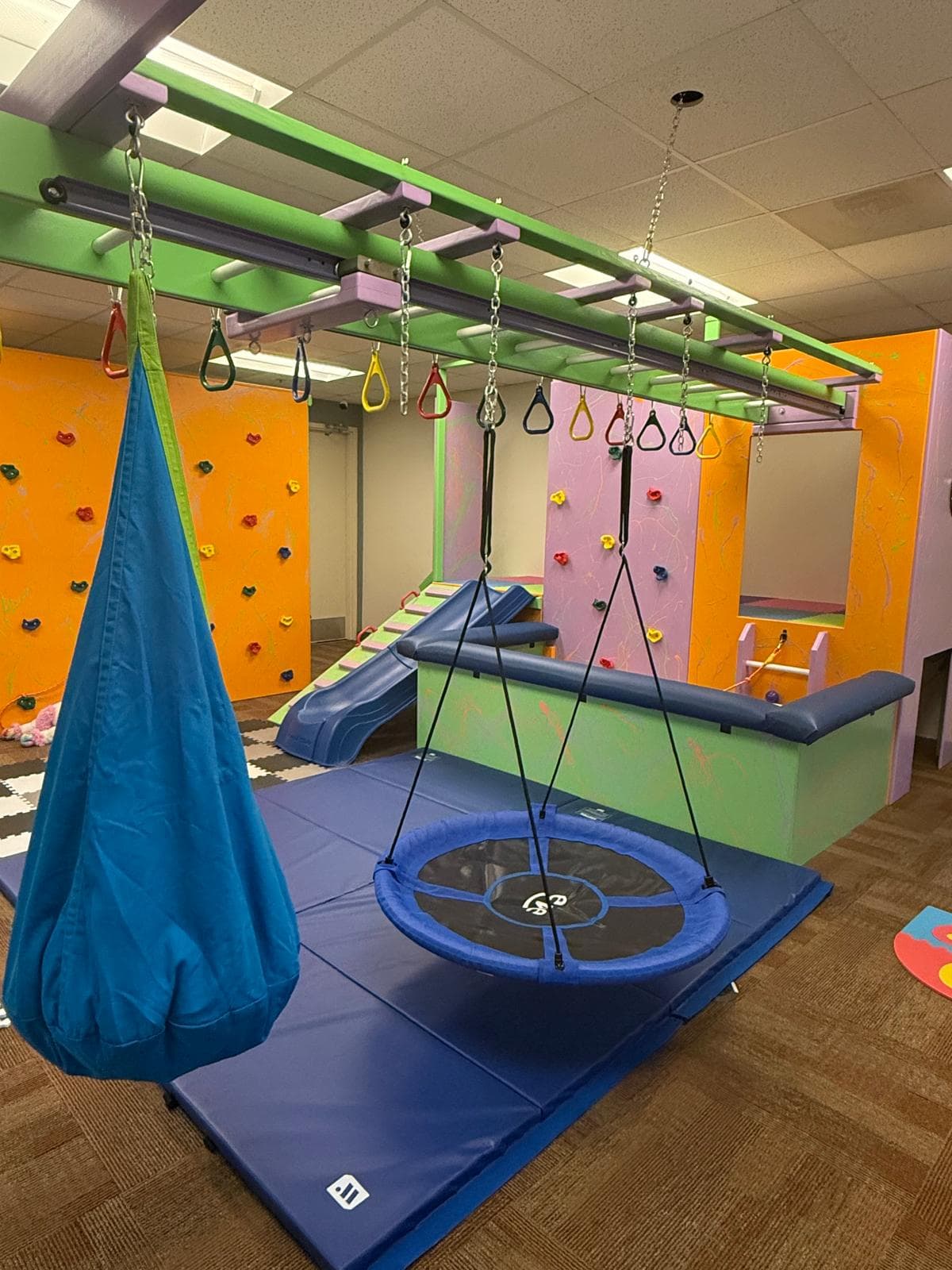 Bright therapy room with sensory stations